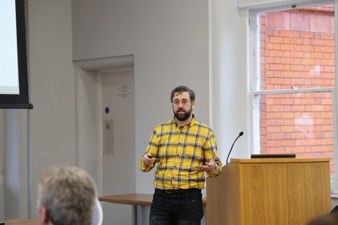 Patrick Ryan in yellow check shirt presenting his pitch